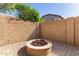 Cozy backyard fire pit area on a well-maintained brick patio surrounded by a block fence at 5423 W Yearling Rd, Phoenix, AZ 85083