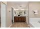 Bright bathroom featuring double vanity, recessed lighting, soaking tub, and neutral tiling at 5423 W Yearling Rd, Phoenix, AZ 85083