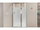 Bathroom featuring a glass-enclosed shower with tiled walls and chrome fixtures at 5423 W Yearling Rd, Phoenix, AZ 85083