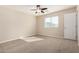 Bright, neutral-toned bedroom featuring carpet floors, ceiling fan, and window at 5423 W Yearling Rd, Phoenix, AZ 85083