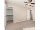 Neutral bedroom featuring carpet, ceiling fan, access to the closet, and an ensuite bath at 5423 W Yearling Rd, Phoenix, AZ 85083
