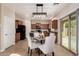Bright eat-in kitchen with a round table and light modern colored chairs and overhead light at 5423 W Yearling Rd, Phoenix, AZ 85083