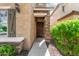 Charming front entrance showcasing a stone column, a gate, and a well-manicured green bush at 5423 W Yearling Rd, Phoenix, AZ 85083
