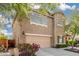 Charming two-story home with an attached two-car garage and beautiful flowers in the front yard at 5423 W Yearling Rd, Phoenix, AZ 85083