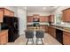 Modern kitchen with a center island, granite counters, stainless steel appliances, and ample cabinet space at 5423 W Yearling Rd, Phoenix, AZ 85083