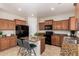 Well-lit kitchen with updated appliances, granite countertops, and stylish bar seating at 5423 W Yearling Rd, Phoenix, AZ 85083
