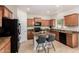 Updated kitchen featuring stainless steel appliances, center island, granite counters, and tile flooring at 5423 W Yearling Rd, Phoenix, AZ 85083