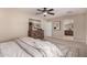 Bright primary bedroom featuring a ceiling fan, modern dresser, and views to the ensuite at 5423 W Yearling Rd, Phoenix, AZ 85083