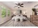Comfortable primary bedroom with large windows, ceiling fan, and plush rug for a cozy retreat at 5423 W Yearling Rd, Phoenix, AZ 85083