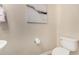 Bright half-bath with modern fixtures, white toilet, and minimalist artwork creating a clean aesthetic at 5423 W Yearling Rd, Phoenix, AZ 85083