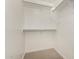 Small walk-in closet with white walls, neutral carpet, and shelving at 5423 W Yearling Rd, Phoenix, AZ 85083