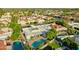 Expansive aerial view of a community with pools, patios, lush landscaping, and red tile roofs at 5718 N 72Nd Pl, Scottsdale, AZ 85250