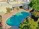 Aerial shot of a backyard featuring a sparkling pool, a covered patio with seating and desert landscaping at 5718 N 72Nd Pl, Scottsdale, AZ 85250
