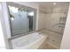 Bright bathroom featuring a soaking tub, a glass shower, and a garden view at 5718 N 72Nd Pl, Scottsdale, AZ 85250