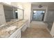 Bathroom with dual sinks, granite countertops, a soaking tub and shower at 5718 N 72Nd Pl, Scottsdale, AZ 85250