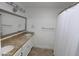 Bathroom with dual sinks, granite countertops, and a shower with white curtain at 5718 N 72Nd Pl, Scottsdale, AZ 85250