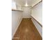Walk-in closet featuring built-in shelving, with wood flooring and bright lighting at 5718 N 72Nd Pl, Scottsdale, AZ 85250