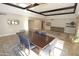 Bright dining area with modern furniture, tile flooring, and a view of the living space at 5718 N 72Nd Pl, Scottsdale, AZ 85250
