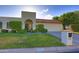 Inviting front yard with lush green lawn, mature shrubs, and a charming terracotta tile roof at 5718 N 72Nd Pl, Scottsdale, AZ 85250