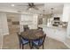 Spacious kitchen with white cabinets, stainless steel appliances, granite countertops, and a dark breakfast table at 5718 N 72Nd Pl, Scottsdale, AZ 85250