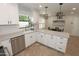 Beautiful kitchen showcasing stainless steel appliances, granite countertops, white subway tile backsplash, and stylish white cabinets at 5718 N 72Nd Pl, Scottsdale, AZ 85250