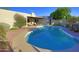 Beautiful swimming pool and patio area perfect for outdoor entertaining, surrounded by mature trees and desert plants at 5718 N 72Nd Pl, Scottsdale, AZ 85250