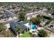 Aerial view of a landscaped home with a private pool and lush green surroundings in a neighborhood at 5751 E Ludlow Dr, Scottsdale, AZ 85254