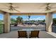 Relaxing balcony with seating and views of palm trees and a quiet neighborhood at 5751 E Ludlow Dr, Scottsdale, AZ 85254