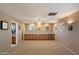 Finished basement with built-in cabinets, neutral carpet, drop ceiling, and natural light from windows at 5751 E Ludlow Dr, Scottsdale, AZ 85254