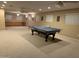 Spacious basement with recessed lighting, ping pong table, and custom built-in storage at 5751 E Ludlow Dr, Scottsdale, AZ 85254