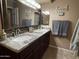 Bathroom with granite countertop, double undermount sinks, framed mirror, and modern decor at 5751 E Ludlow Dr, Scottsdale, AZ 85254
