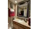 Bathroom with granite countertop, undermount sink, framed mirror, and stylish bath accessories at 5751 E Ludlow Dr, Scottsdale, AZ 85254