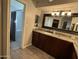 Bathroom vanity with granite countertops and access to the large shower with marble tile at 5751 E Ludlow Dr, Scottsdale, AZ 85254