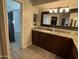 Bathroom vanity with granite countertops and access to the large shower with marble tile at 5751 E Ludlow Dr, Scottsdale, AZ 85254
