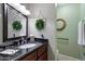 Charming powder room featuring a black granite countertop and elegant framed wall decor at 5751 E Ludlow Dr, Scottsdale, AZ 85254