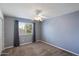 Serene bedroom with neutral gray walls, plush carpeting, and a window providing natural light at 5751 E Ludlow Dr, Scottsdale, AZ 85254