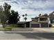 Charming home featuring mature landscaping, palm trees, 2-car garage, and a private second story balcony at 5751 E Ludlow Dr, Scottsdale, AZ 85254