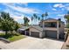 A beautiful two-story home with three-car garage, an upstairs balcony, and mature landscaping at 5751 E Ludlow Dr, Scottsdale, AZ 85254