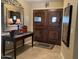 Elegant foyer features a beautiful mirror, a decorative table with lamps and a grand, double-door entry at 5751 E Ludlow Dr, Scottsdale, AZ 85254