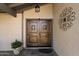 Beautiful, custom double front doors with iron detailing create an inviting entrance to this home at 5751 E Ludlow Dr, Scottsdale, AZ 85254