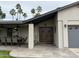 Charming front porch with wooden doors, tile flooring, sitting area, and two car garage at 5751 E Ludlow Dr, Scottsdale, AZ 85254