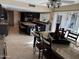 Spacious kitchen with granite countertops and dark cabinetry, plus a dining area and access to a large outdoor pool at 5751 E Ludlow Dr, Scottsdale, AZ 85254