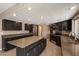 Spacious kitchen featuring granite countertops, an island, stainless steel appliances, and dark cabinetry at 5751 E Ludlow Dr, Scottsdale, AZ 85254