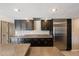 Well-lit kitchen featuring stainless steel refrigerator, granite countertops and ample dark wood cabinetry at 5751 E Ludlow Dr, Scottsdale, AZ 85254
