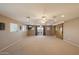 Spacious living room featuring ceiling fans, access to a covered patio and a sliding barn door at 5751 E Ludlow Dr, Scottsdale, AZ 85254