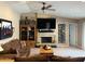 Comfortable living room with a stone fireplace, a large flat-screen TV, and cozy furniture at 5751 E Ludlow Dr, Scottsdale, AZ 85254