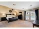 Spacious primary bedroom with vaulted ceiling, ceiling fan, and access to the pool area at 5751 E Ludlow Dr, Scottsdale, AZ 85254