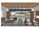 Clubhouse view with indoor-outdoor living space opening up to a pool area with cabanas and seating at 6228 N Cattle Track Rd, Scottsdale, AZ 85250