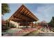 Stunning exterior showcases a modern home with an open-air patio, lush landscaping, and a pathway at 6228 N Cattle Track Rd, Scottsdale, AZ 85250