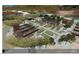 Aerial view of an organic garden featuring raised beds, pergola-covered seating areas, and mature trees at 6228 N Cattle Track Rd, Scottsdale, AZ 85250